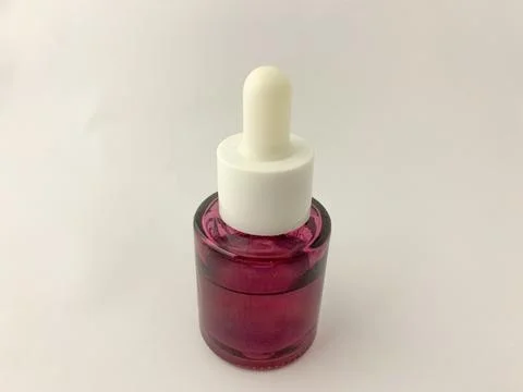 Plastic bottle dropper with white cap. Stock Photos