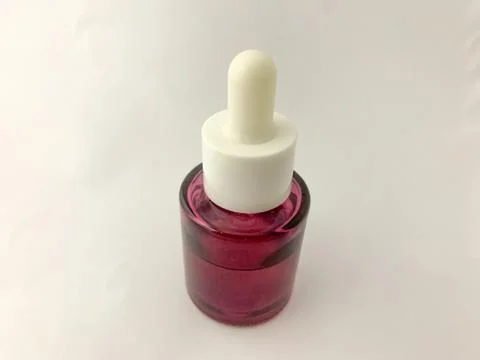 Plastic bottle dropper with white cap. Stock Photos
