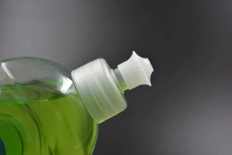 A plastic bottle filled with a light green, green liquid. Stock-Fotos