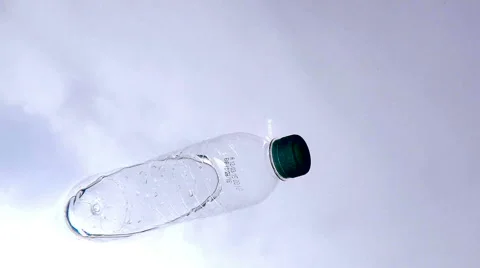 Plastic Bottle Floating Against a Blue Sky From an Underwater Perspective. Stock Footage 51167892