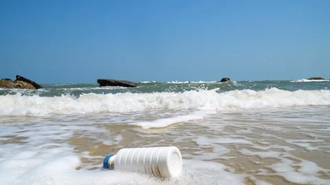 Plastic Bottle Floating Along ocean beach. Environmental pollution 4k Stock Footage 107047685