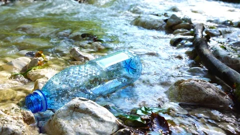 Plastic bottle floating in beautiful mountain river Video stock 96855895