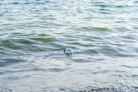 Plastic bottle floating in the ocean. Concept of pollution and garbage being Stock Photos