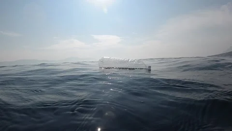 Plastic bottle floating in the ocean. Stock Footage 146659489