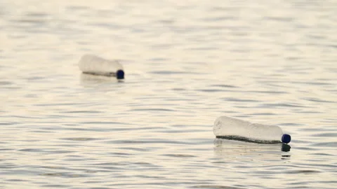 Plastic bottle floating in ocean surface, polluted water, garbage Stock Footage 336491625