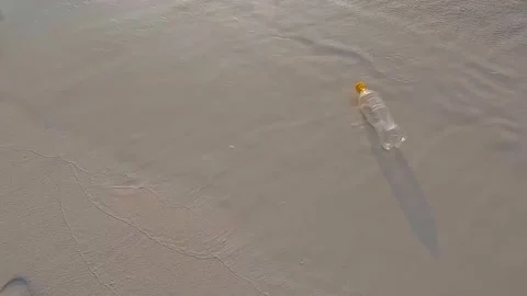 A plastic bottle floating in the sea in a beach with dirty coast Stock Footage 242421876