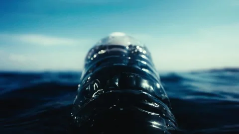 Plastic bottle floating on water surface Stock Footage 241557769