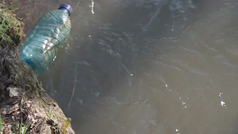 A plastic bottle floats on the river. Stock Footage 188279681