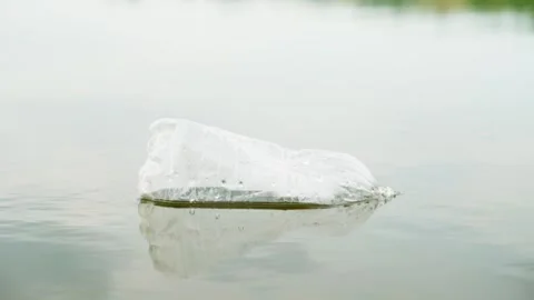 A plastic bottle floats in water. The problem of environmental pollution. Stock Footage 246480505