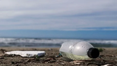 Plastic bottle garbage on sea ecosystem over blurred waves motion background,4k Video stock 119486274