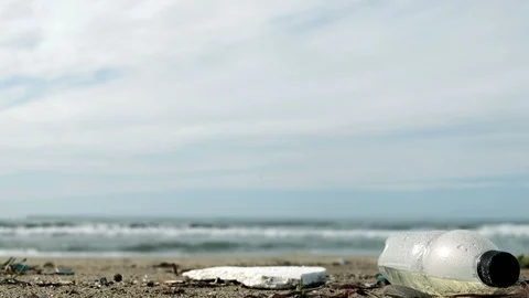 Plastic bottle garbage on sea ecosystem over waves motion background,zoom out 4k Stock Footage 121227315