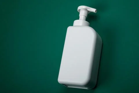 Plastic bottle on green background. High density polyethylene packaging for r Stock Photos