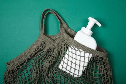 Plastic bottle on green background. High density polyethylene packaging for r Stock Photos