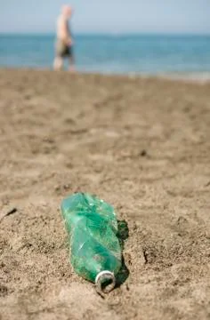 Plastic bottle left on a sandy beach. Stock Photos