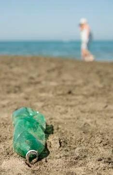 Plastic bottle left on a sandy beach. Stock Photos