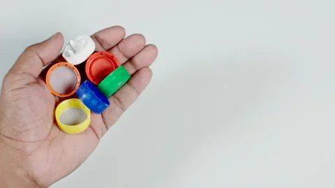 Plastic Bottle Lids In a Hand Stock Footage 248756900