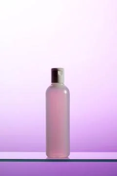 A plastic bottle with liquid cosmetics and tonic stands on a glass shelf Stock Illustration