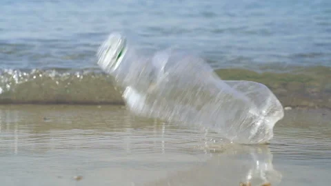 Plastic bottle literring and the clean beach. Slowmotion. Stock Footage 116021578