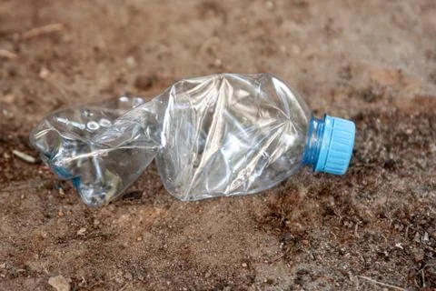 A plastic bottle is lying on the ground. Environmental pollution concept. Stock Photos