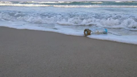 A plastic bottle is lying on a sandy beach. Video stock 151628555