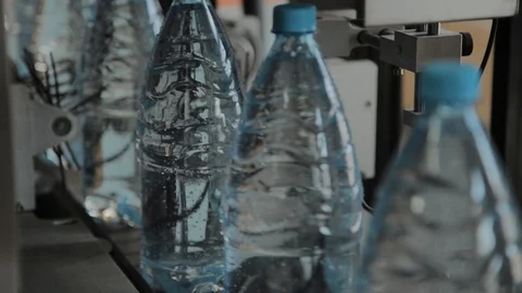 Plastic bottle manufacturing line. Plastic molding bottling factory. Blanks of Stock-Footage 105979770