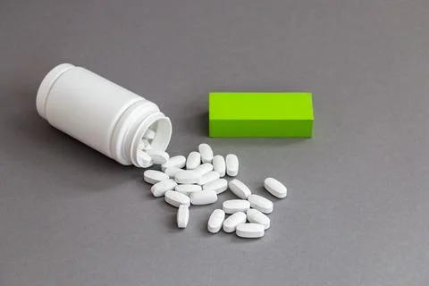 Plastic bottle with multivitamins on gray background Stock Photos