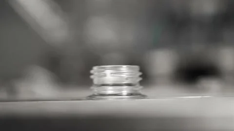 Plastic bottle necks move along a conveyor line in a water bottling plant Stock Footage 161902740