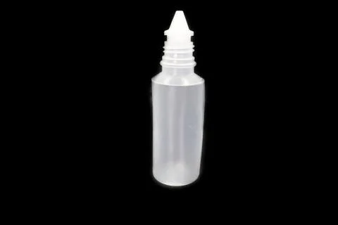 Plastic bottle of normal saline isolated on black background. Stock Photos