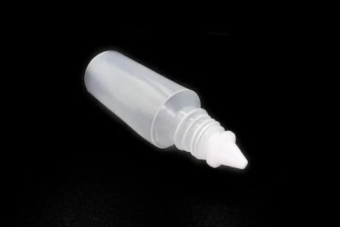 Plastic bottle of normal saline isolated on black background. Stock Photos