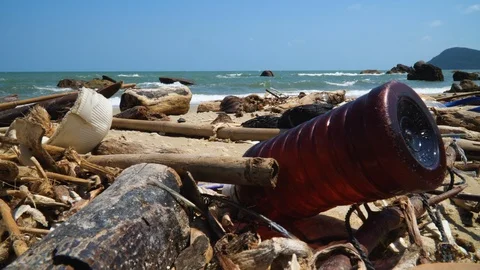 Plastic bottle on the ocean beach with waves on the background. Environmental Stock Footage 108888415