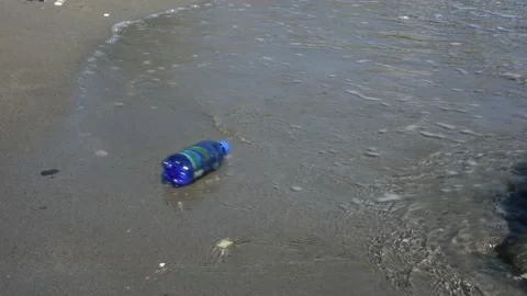 Plastic bottle - pollution on the beach Stock Footage 136666222
