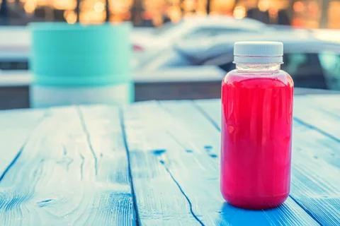 Plastic bottle with red fruit drink in restaurant Foto stock