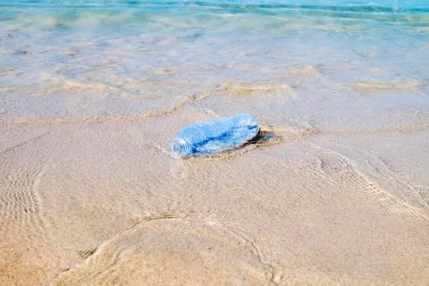 Plastic bottle on sand beach Stock Photos