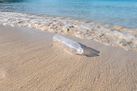 Plastic bottle on sand beach Stock Photos