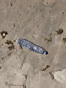 Plastic bottle in the sand Stock Photos