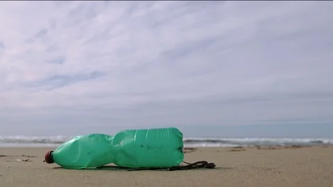 Plastic bottle on sea ecosystem over blurred waves motion background,planet save Stock Footage 119392400