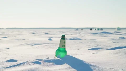 A plastic bottle in the snow on the lake. The problem of pollution of nature. Stock Footage 261358048