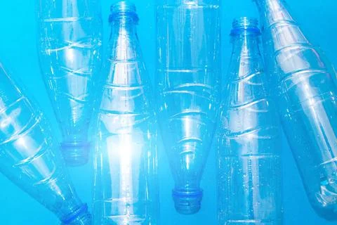 Plastic bottle on a solid blue background. Protect the environment. Second... Stock Photos