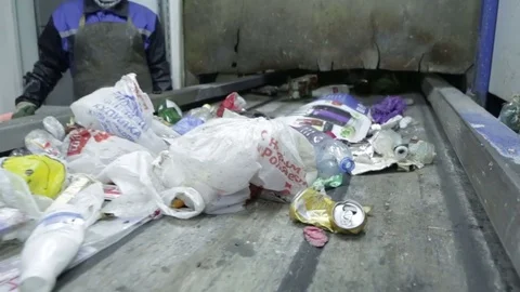 Plastic bottle on the sorting conveyor. Waste sorting. Recycling waste Stock Footage 70353149