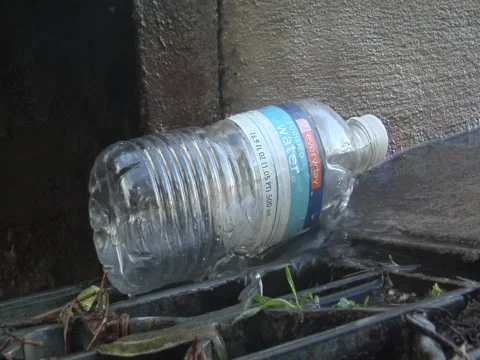 Plastic bottle on storm drain Video stock 609694