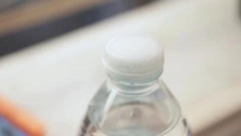 Plastic Bottle with Tethered Cap – New EU Regulation on Attached Caps Stock Footage 318714877
