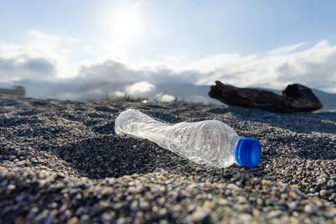 Plastic bottle trash on the beach, pollution problem concept Stock Photos