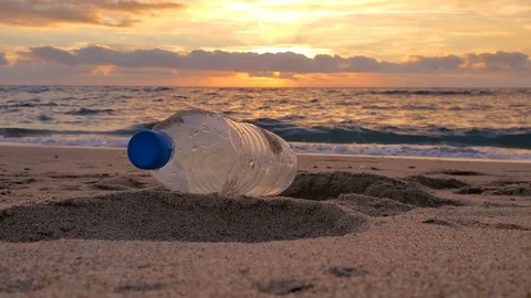 Plastic bottle trash on sandy sea shore sunset motion,polluted nature,cilento Stock Footage 125235165