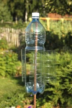 A plastic bottle turn by wind and make vibrations for frightening rodents Stock Photos