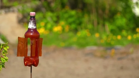 Plastic bottle turns in wind to scare birds Stock Footage 80216275