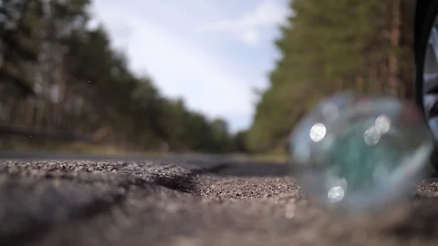 A plastic bottle was thrown out of the car window onto the road. A bottle falls Stock Footage 117799941