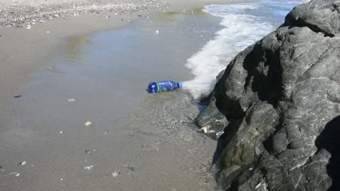 Plastic bottle waste on the beach Stock Footage 136666995