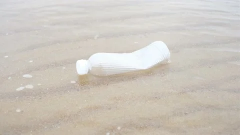 Plastic bottle in the water on the beach close-up. Stock Footage 200374673
