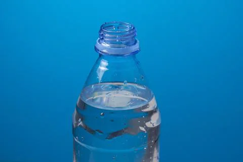 Plastic bottle with water on a blue background Stock Photos