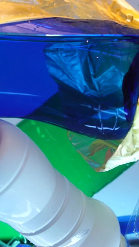 Plastic Bottles and Bags in Clear Water, Vertical View, Microplastic Stock Footage 289764165